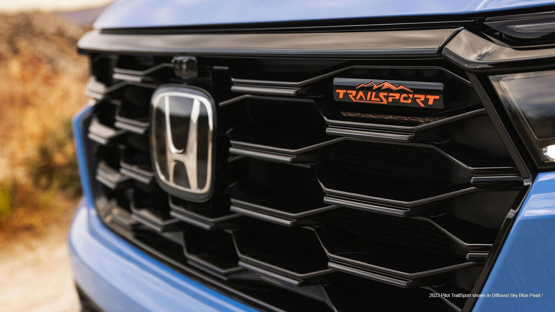 front grille of 2023 Honda Pilot TrailSport shown in Diffused Sky Blue Pearl