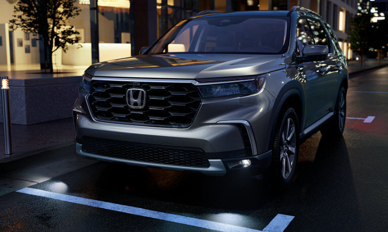 2025 Honda Pilot parked on city street at night