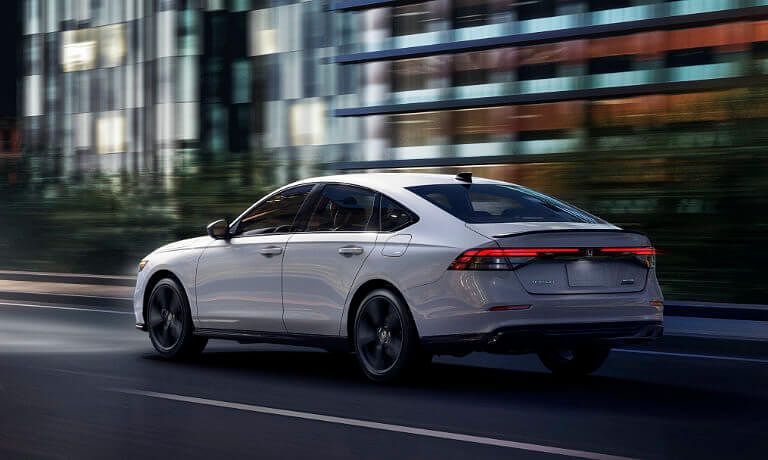 2024 Honda Accord driving on a highway in city