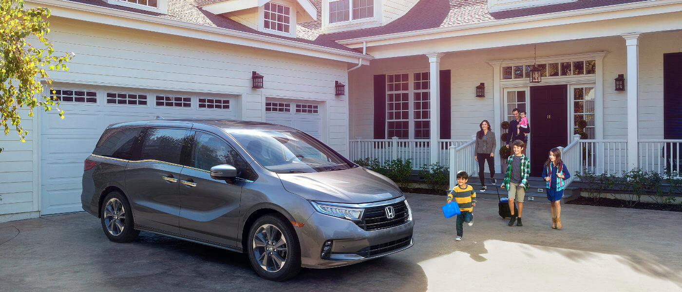 2024 Honda Odyssey parked outside a family home