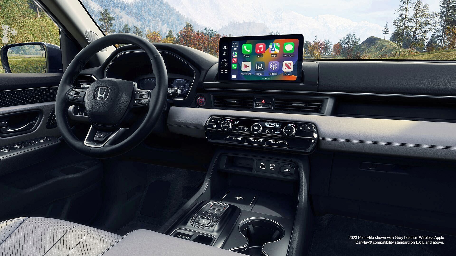Interior of 2023 Honda Pilot Elite shown with Gray Leather. Wireless Apple CarPlay compatibility standard on EX-L and above.