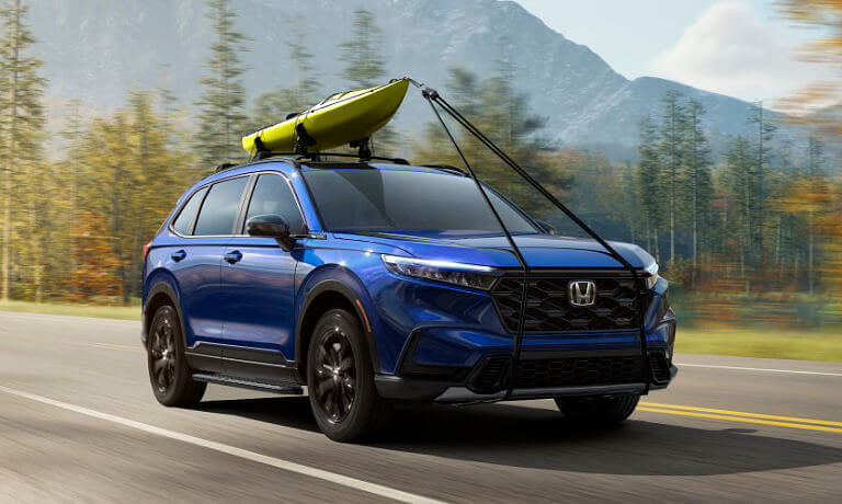 2024 Honda CR-V driving with a kayak on top