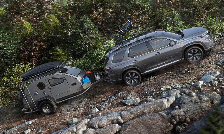 2024 Honda Pilot towing a camper up mountain